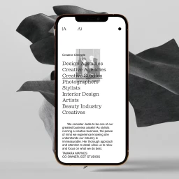 Smartphone displaying a clean digital portfolio website interface against a sculptural draped background