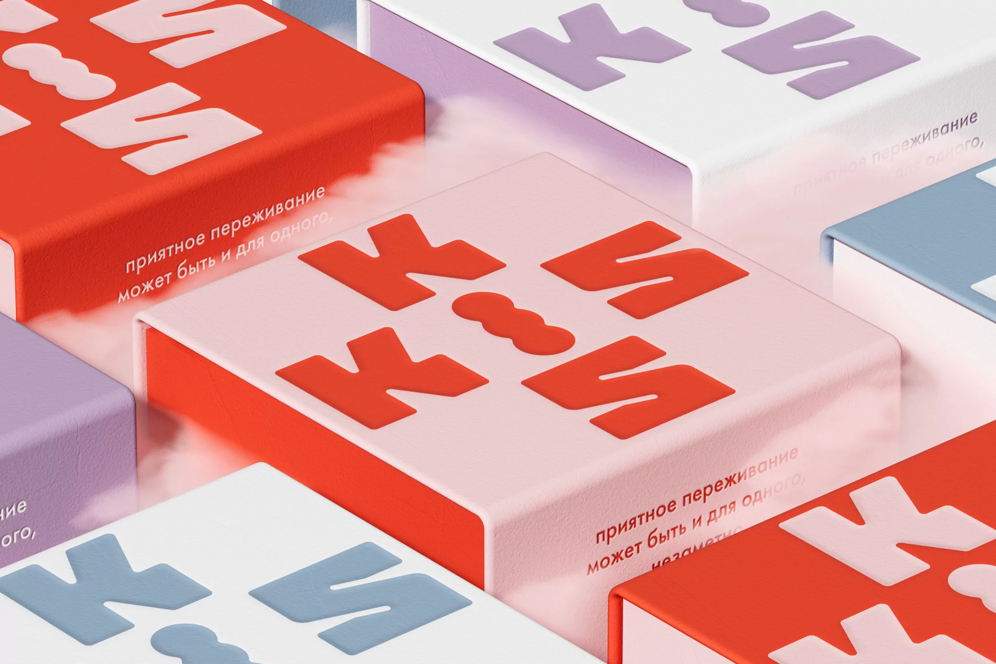 Geometric product packaging featuring raised lettering in red, lilac, and teal against white, pink, and blue boxes arranged in a grid.