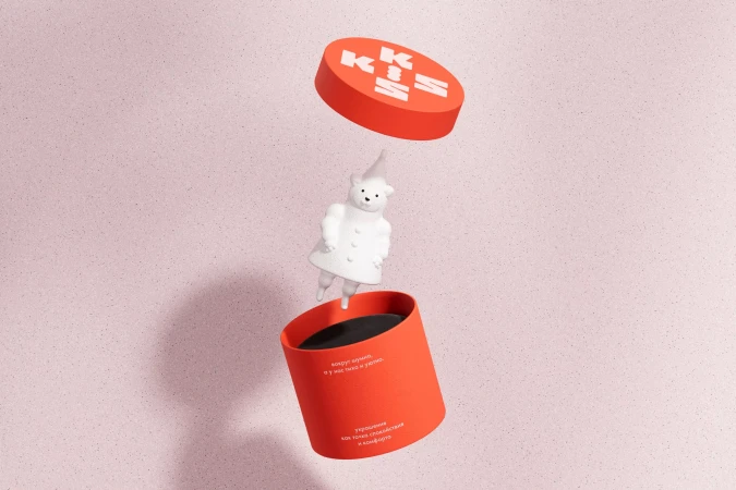 Product shot of a red box with a lid and white bear figure floating above an open container against a light pink background.