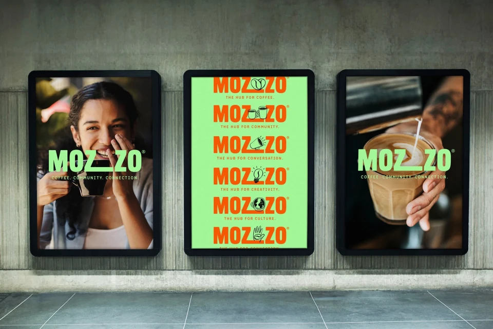 Three illuminated advertising posters on a gray wall, promoting Mozzo coffee with images of a woman drinking and coffee being poured.