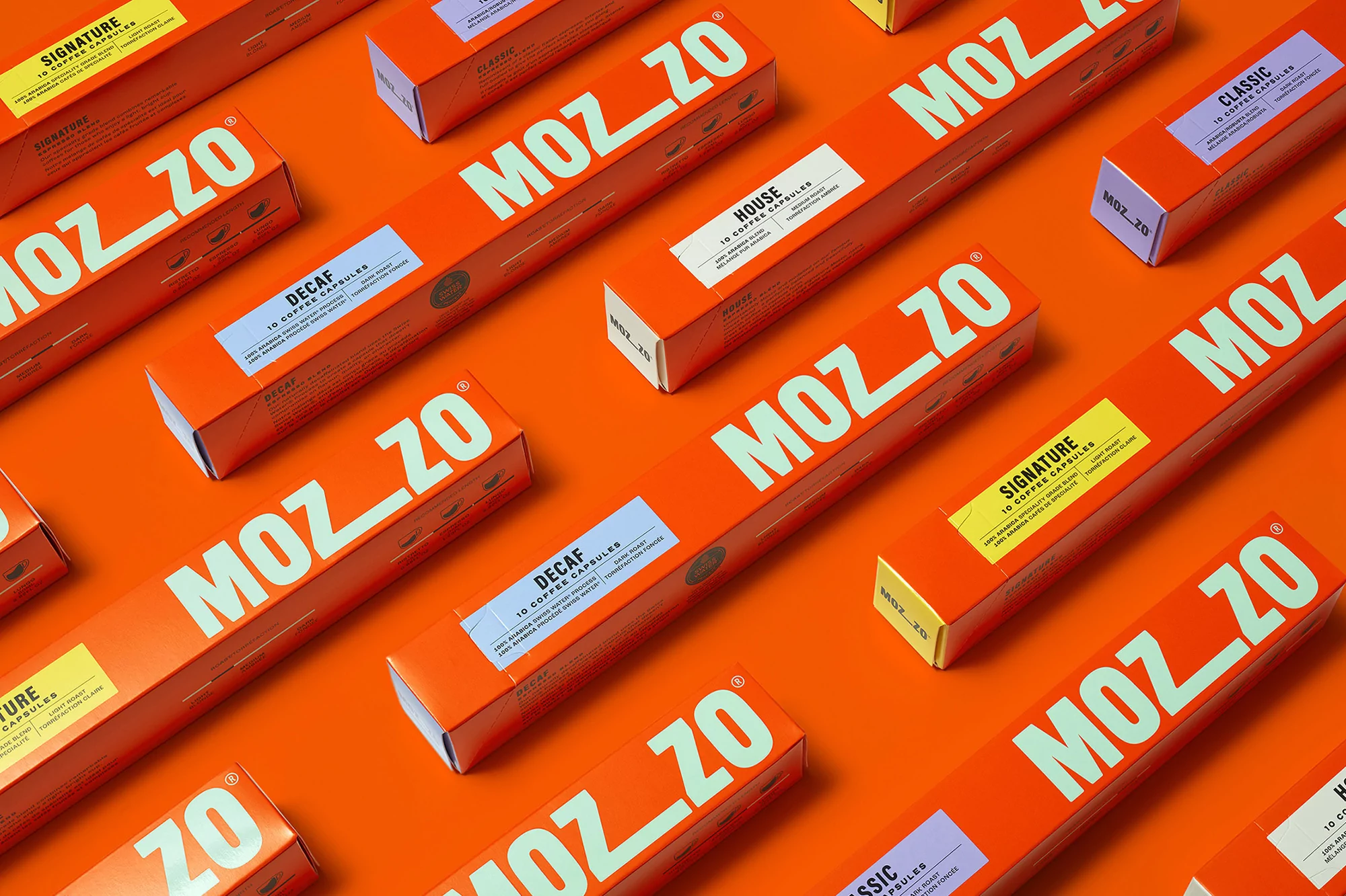 Arrangement of orange boxes of Mozzo coffee capsules with white text labels set against a matching orange background.