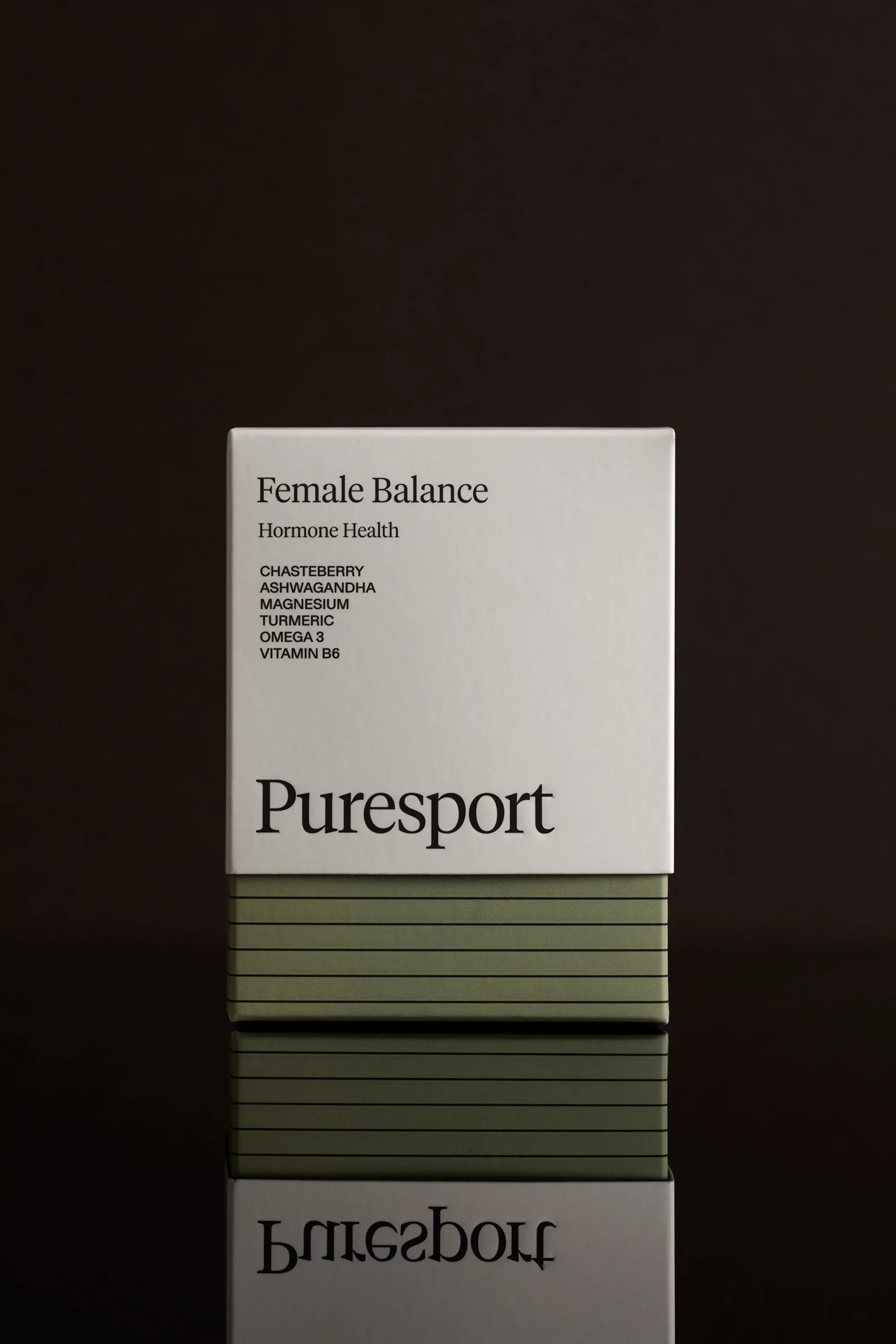 Puresport Female Balance supplement box against a dark background with reflection. The box is white with black text and olive green stripes.