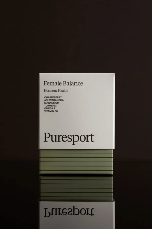 Puresport Female Balance supplement box against a dark background with reflection. The box is white with black text and olive green stripes.