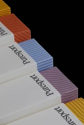 Stack of colourful branded Puresport product boxes with striped patterns against a solid black background.