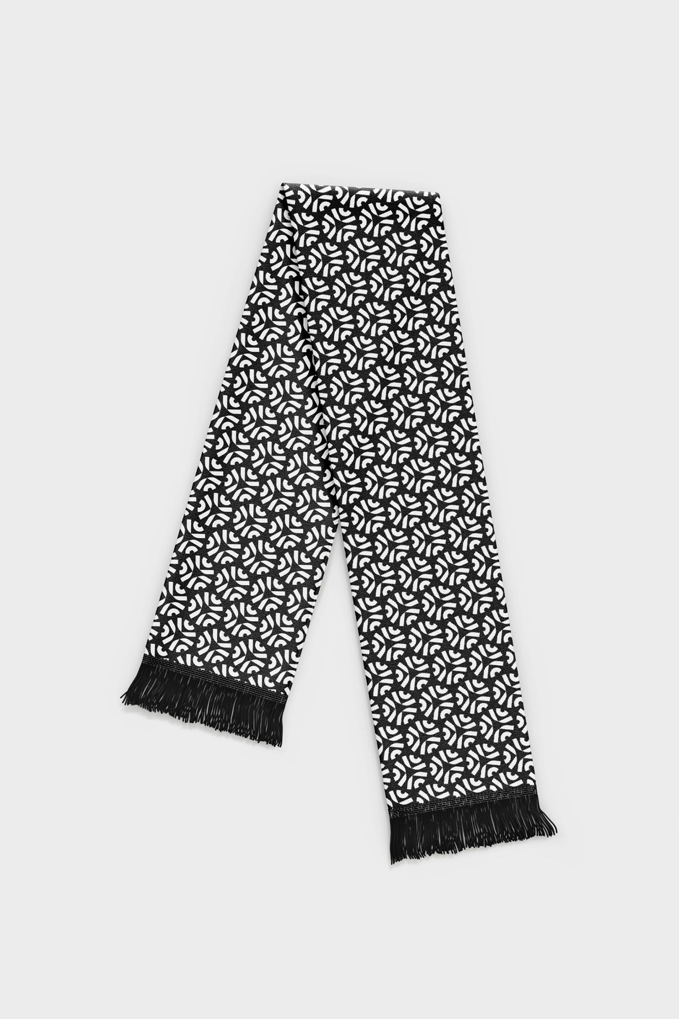 Black and white patterned scarf with fringe on a white background, studio shot, fashion accessory, warm clothing for winter, textile pattern.