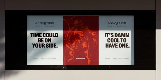 Analog:Shift brand identity billboard featuring typography, bold messaging, and a red astronaut graphic panel.