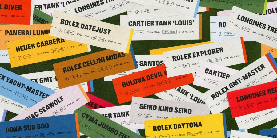 An arrangement of colorful vintage watch specification tags and labels scattered over a green leather surface.