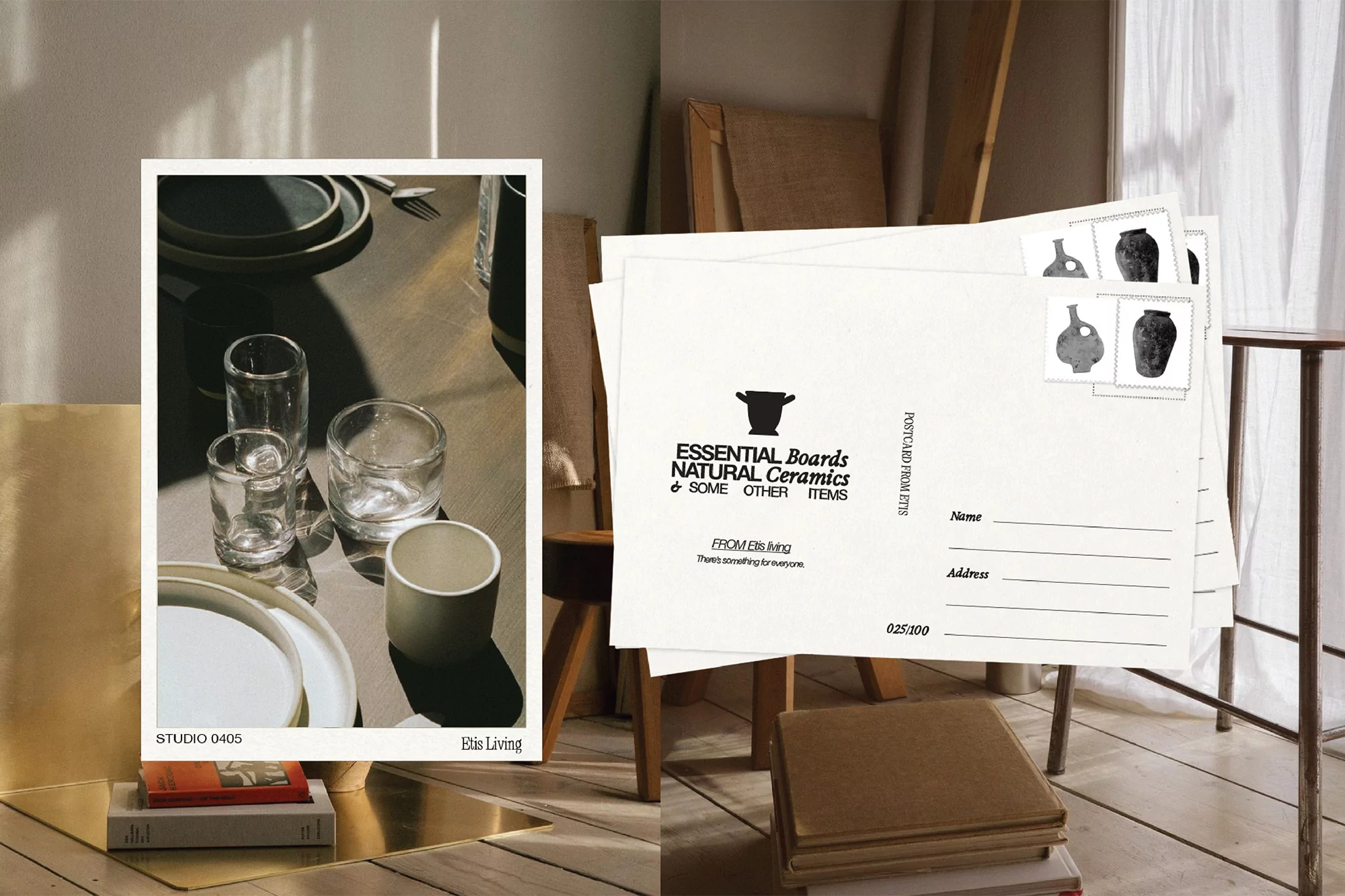 Still life with kitchenware, plates, and postcards featuring ceramics arranged on a light-toned wooden floor with shadows.