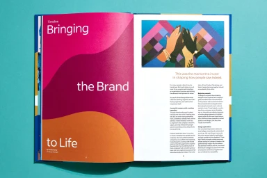 Open magazine spread displaying brand identity guidelines for Indeed with colorful abstract graphics and typography.