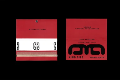 Open red rolling paper packaging with bold black branding and white paper inserts against a solid black background.