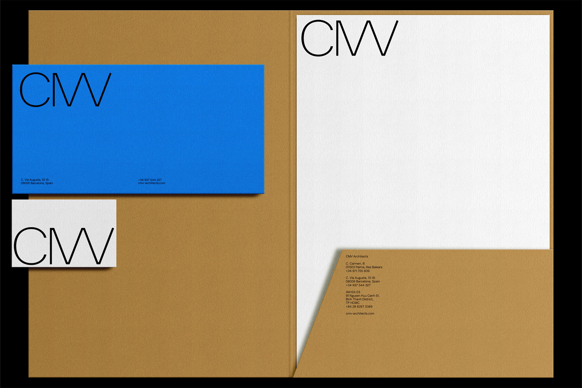 CMV Architects stationery set featuring a blue business card and letterhead, set against a tan folder background.