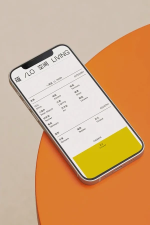 A smartphone displaying a minimalist web interface resting on a vibrant orange curved surface.