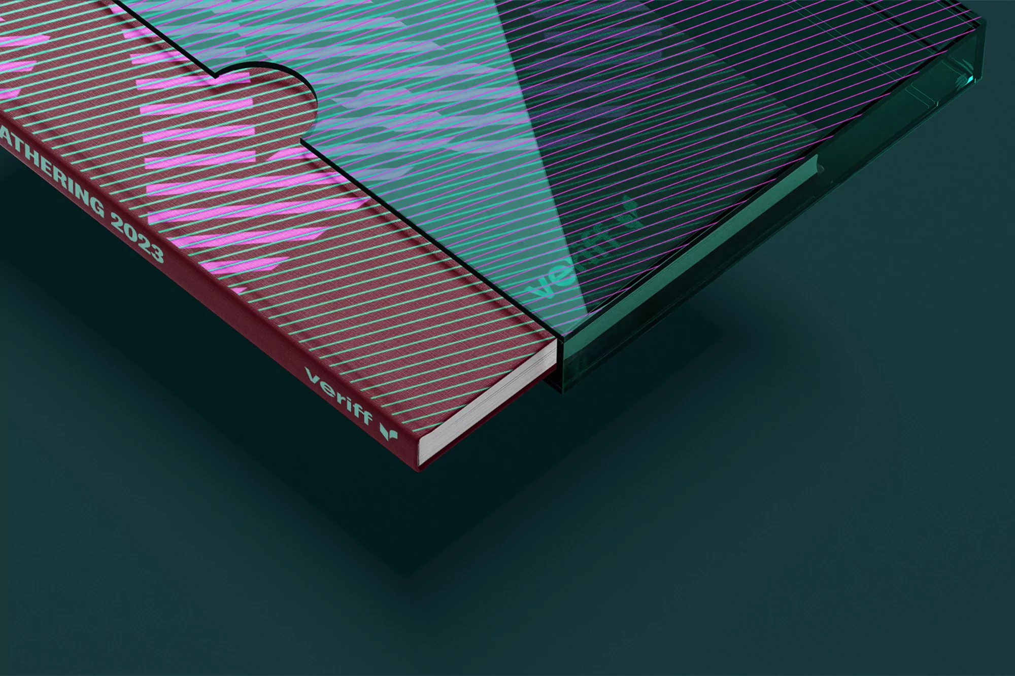 Close-up of a book with a translucent case, displaying a modern design with geometric patterns and a deep teal and magenta color scheme.