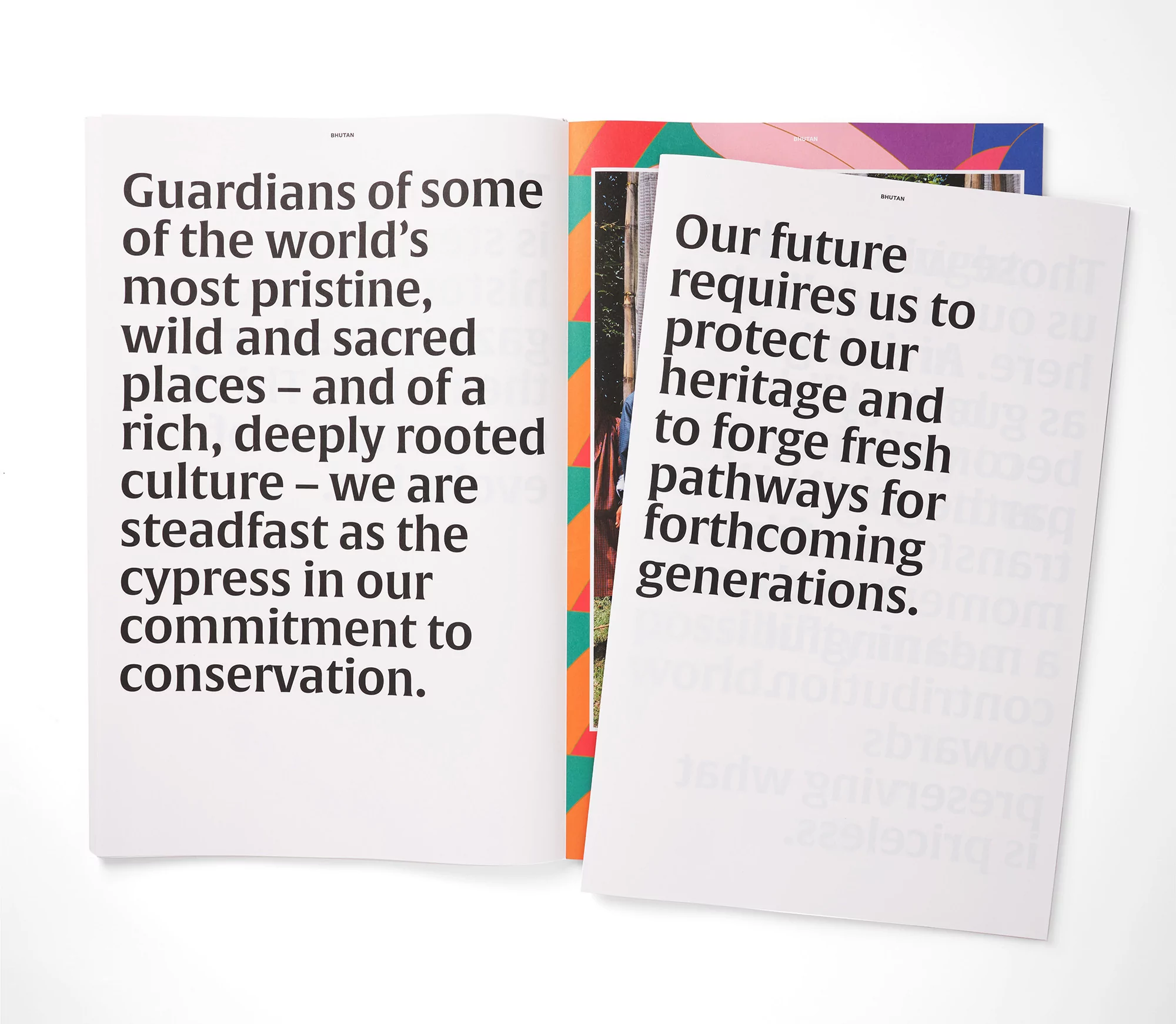 Open book with printed text on white paper, with colorful design on the inner spine and pages, conveys a message about heritage.