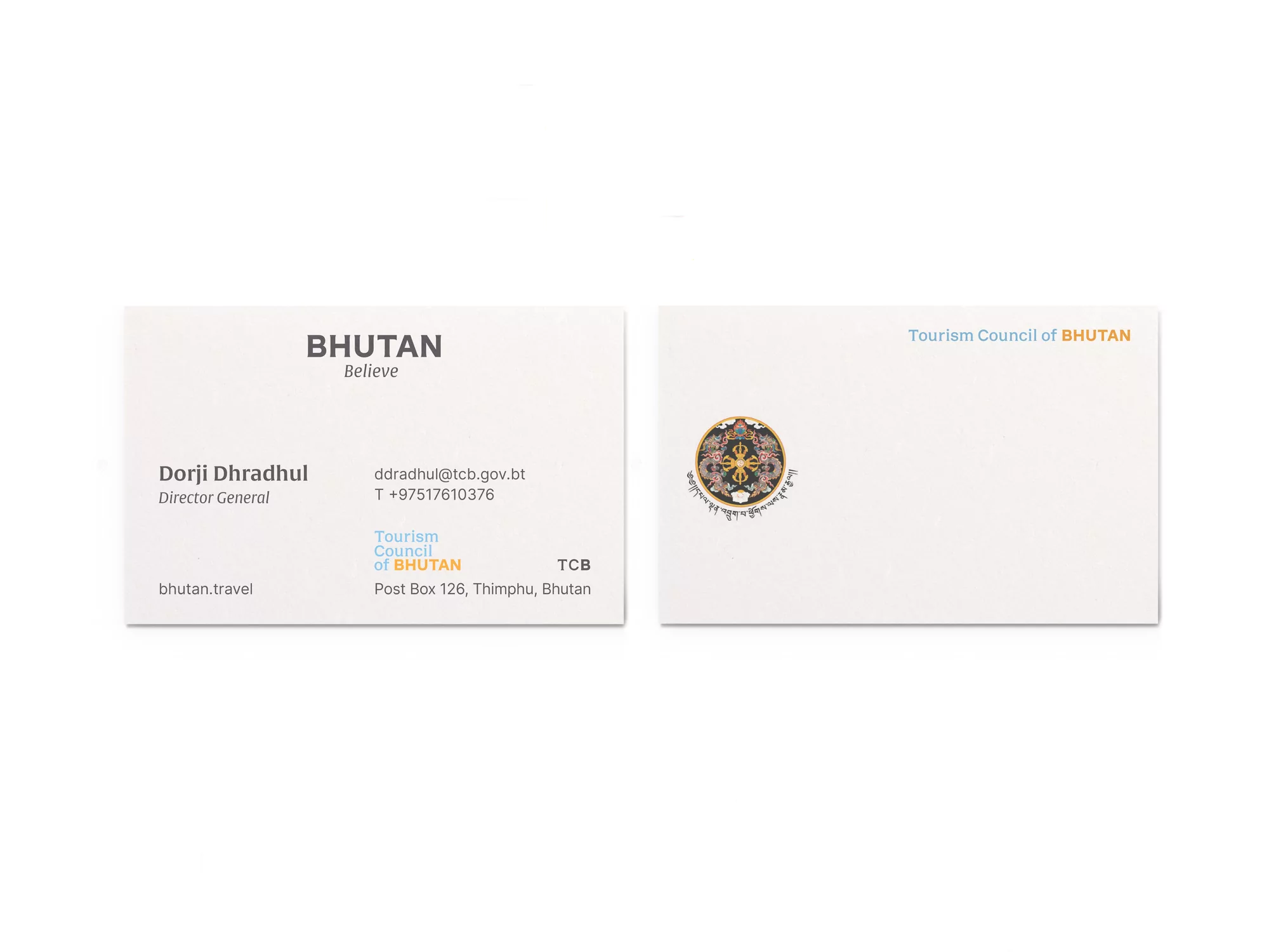 Two business cards with Bhutan Tourism Council branding, contact information, and official logos. One card features Dorji Dhradhul's details.