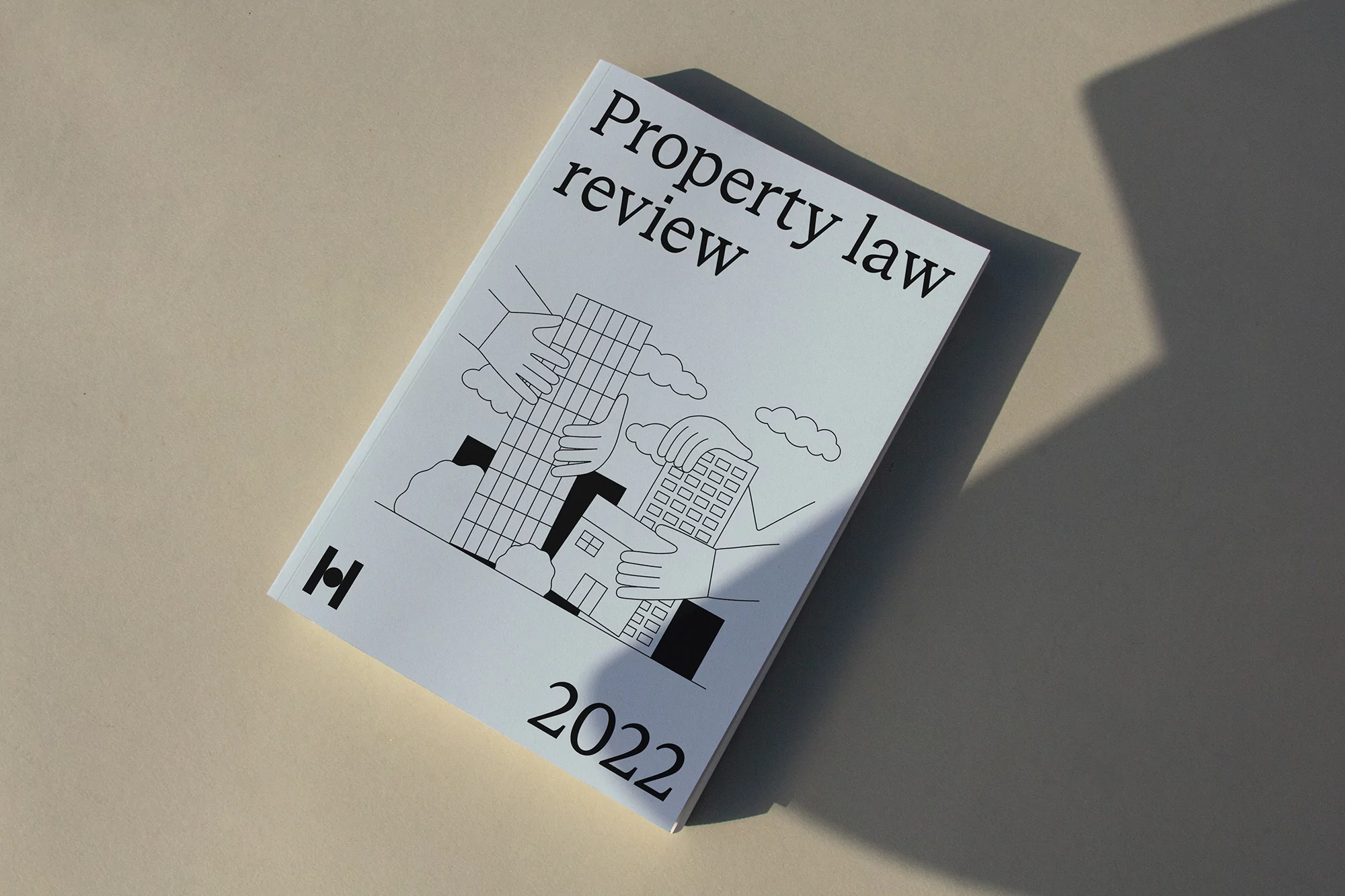 White 'Property Law Review 2022' journal featuring a cover with a graphic architectural illustration and modern typography, on a beige surface.
