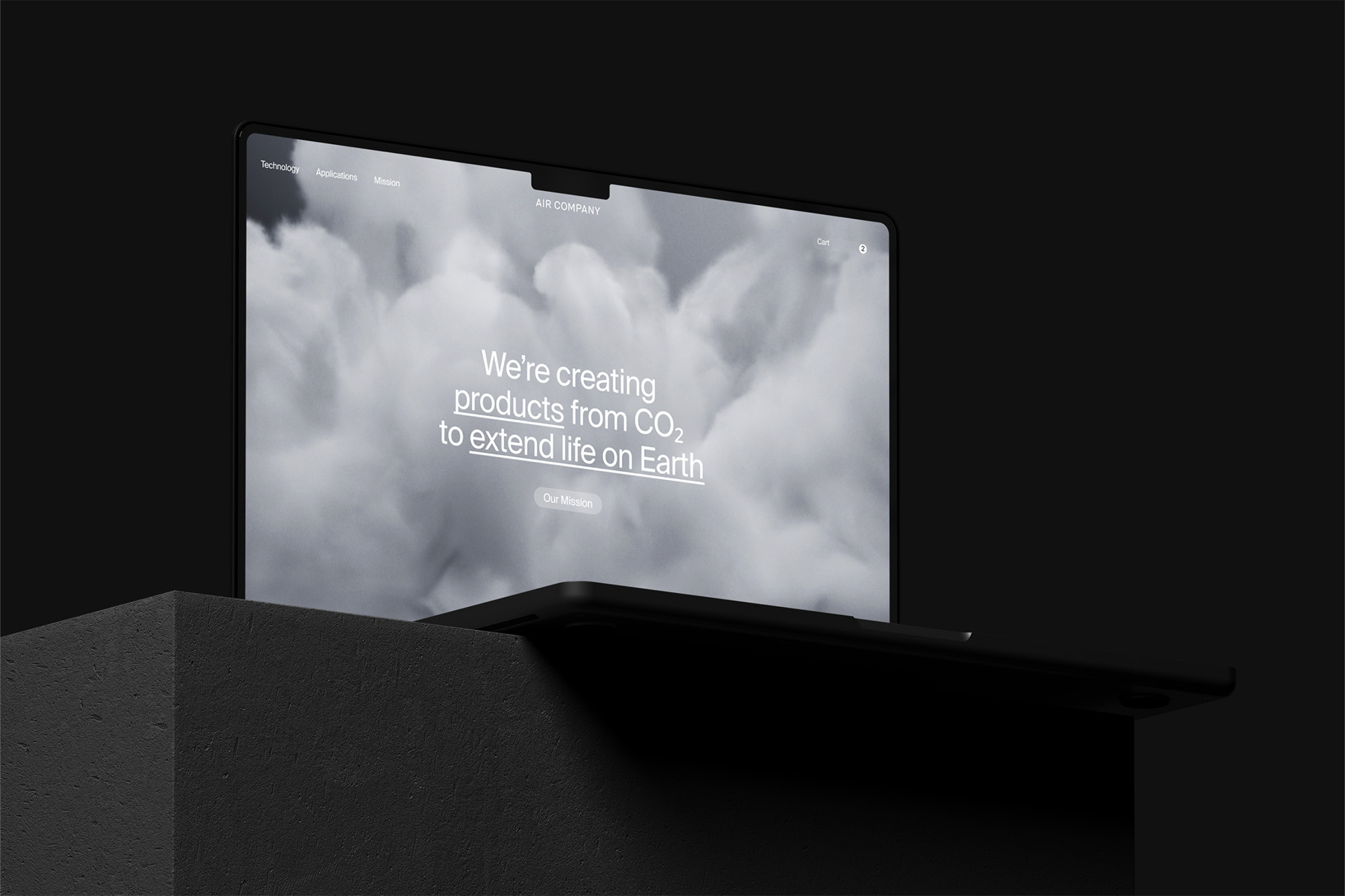 Laptop displaying AIR COMPANY website, featuring smoke background and text: 'We're creating products from CO2 to extend life on Earth'.