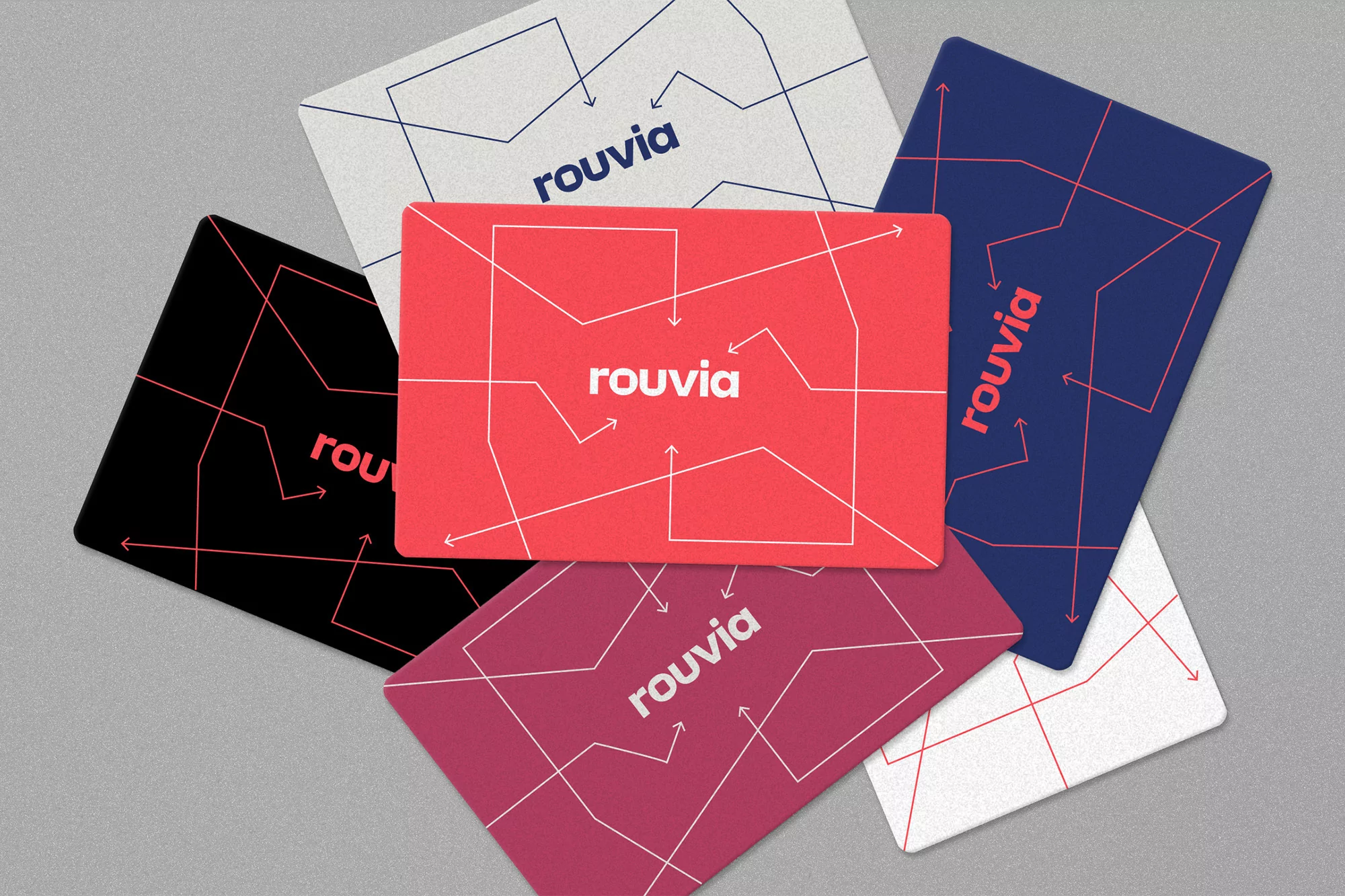 Close-up of colorful Rouvia cards displaying geometric designs and the brand name, presented against a neutral gray backdrop.