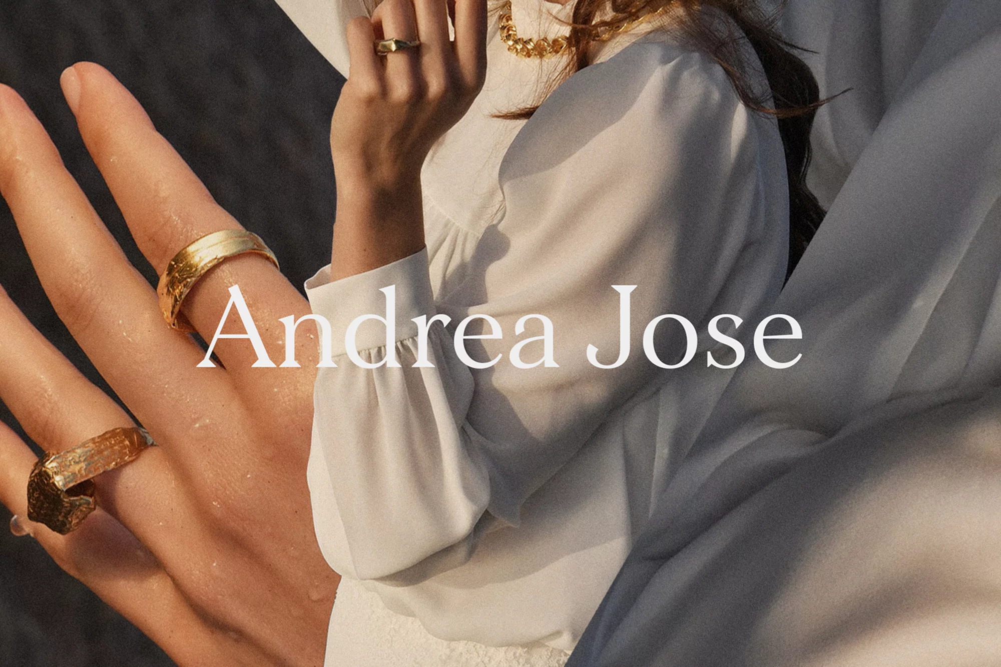 Close-up of woman wearing gold rings and a white blouse with text overlay reading Andrea Jose