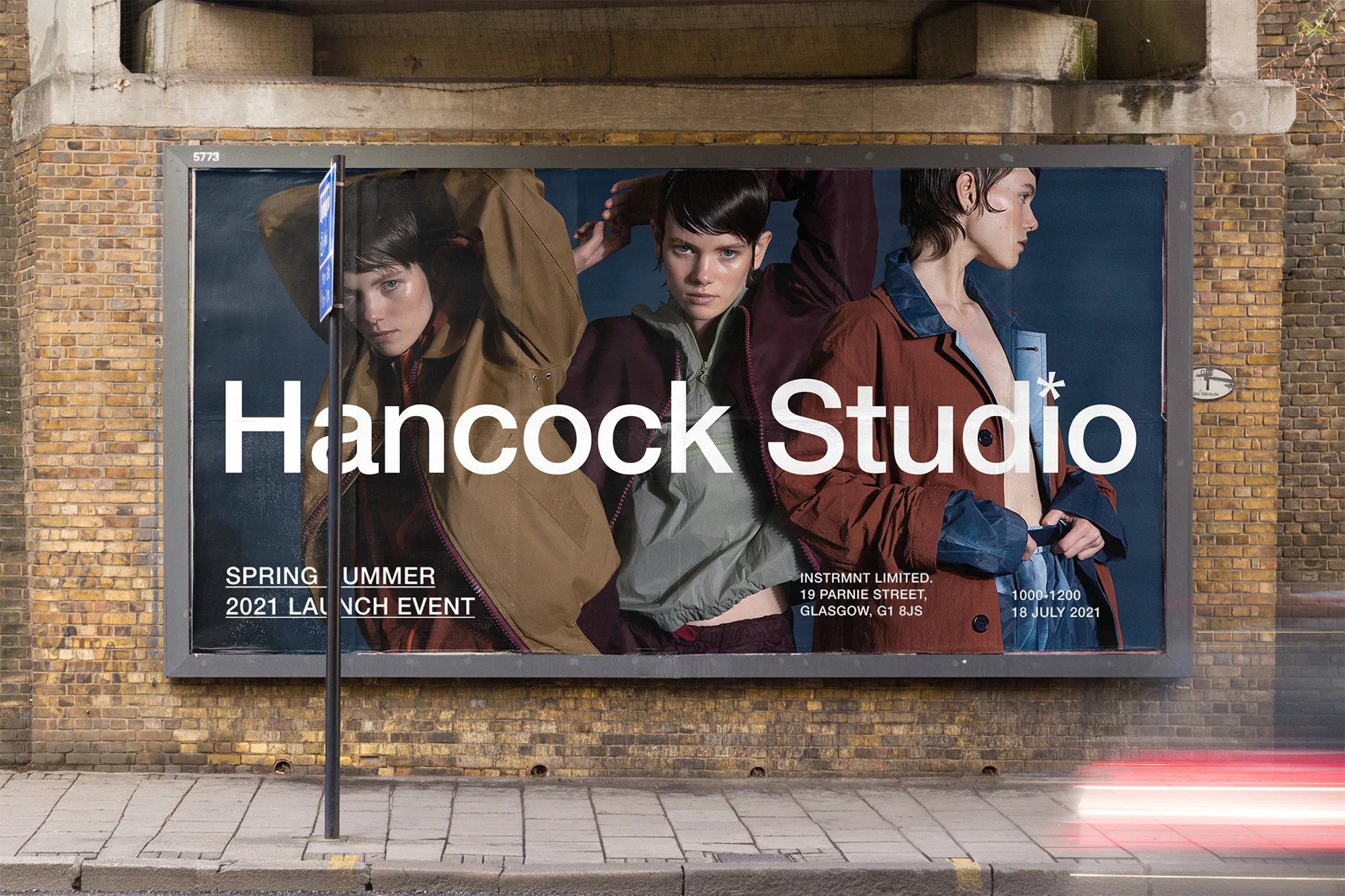 Fashion campaign billboard features three women wearing jackets in an urban setting, advertising Hancock Studio's spring/summer collection.