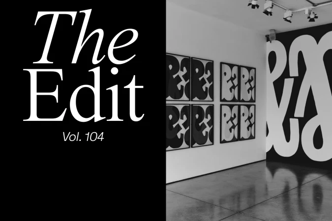 Black and white photograph of a gallery installation with graphic black and white art pieces and 'The Edit Vol. 104' text overlay.