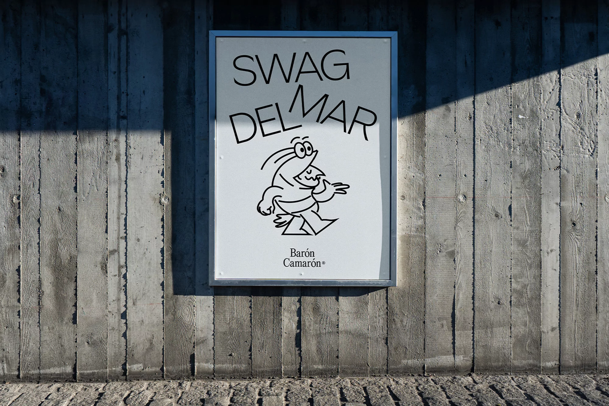 Eye-level shot of a poster on a concrete wall featuring a cartoon shrimp with the text 'SWAG DEL MAR' and 'Baron Camaron'.