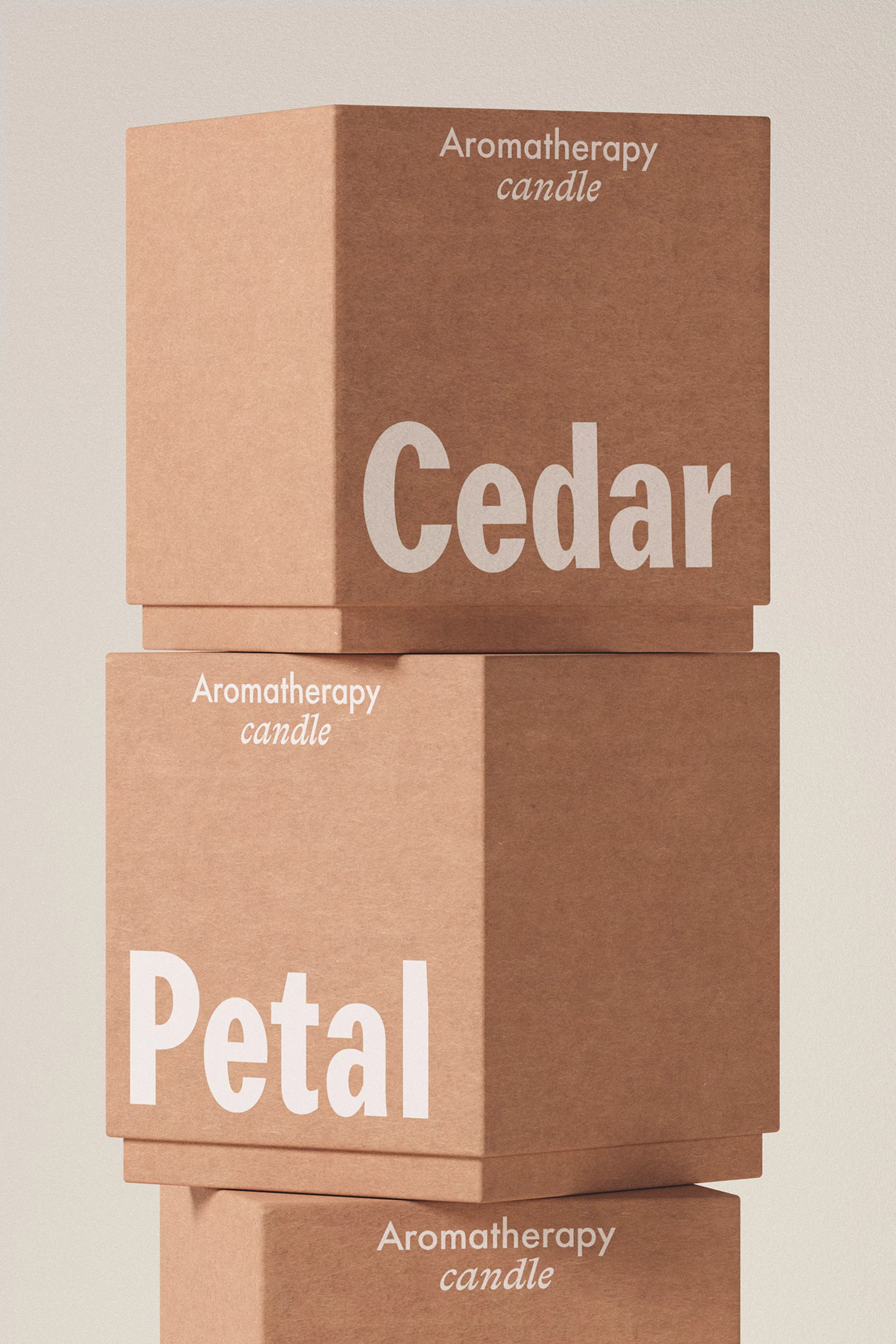 Stack of aromatherapy candle boxes featuring Cedar and Petal scents, minimalist design, and neutral color palette.