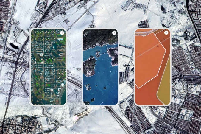 Aerial view shows three smartphones displaying satellite imagery over a snow-covered urban landscape, showcasing mapping technology.