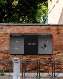 Three promotional posters mounted on an aged brick wall featuring branding and graphic design for Interval