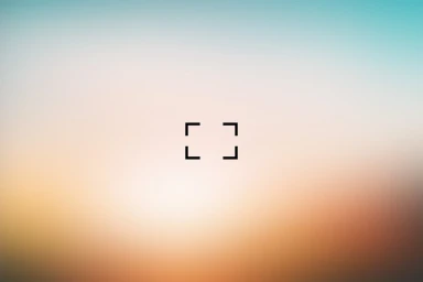 Gradient blur background with soft pastel tones of blue, white, and orange, featuring a black camera autofocus frame in the center.