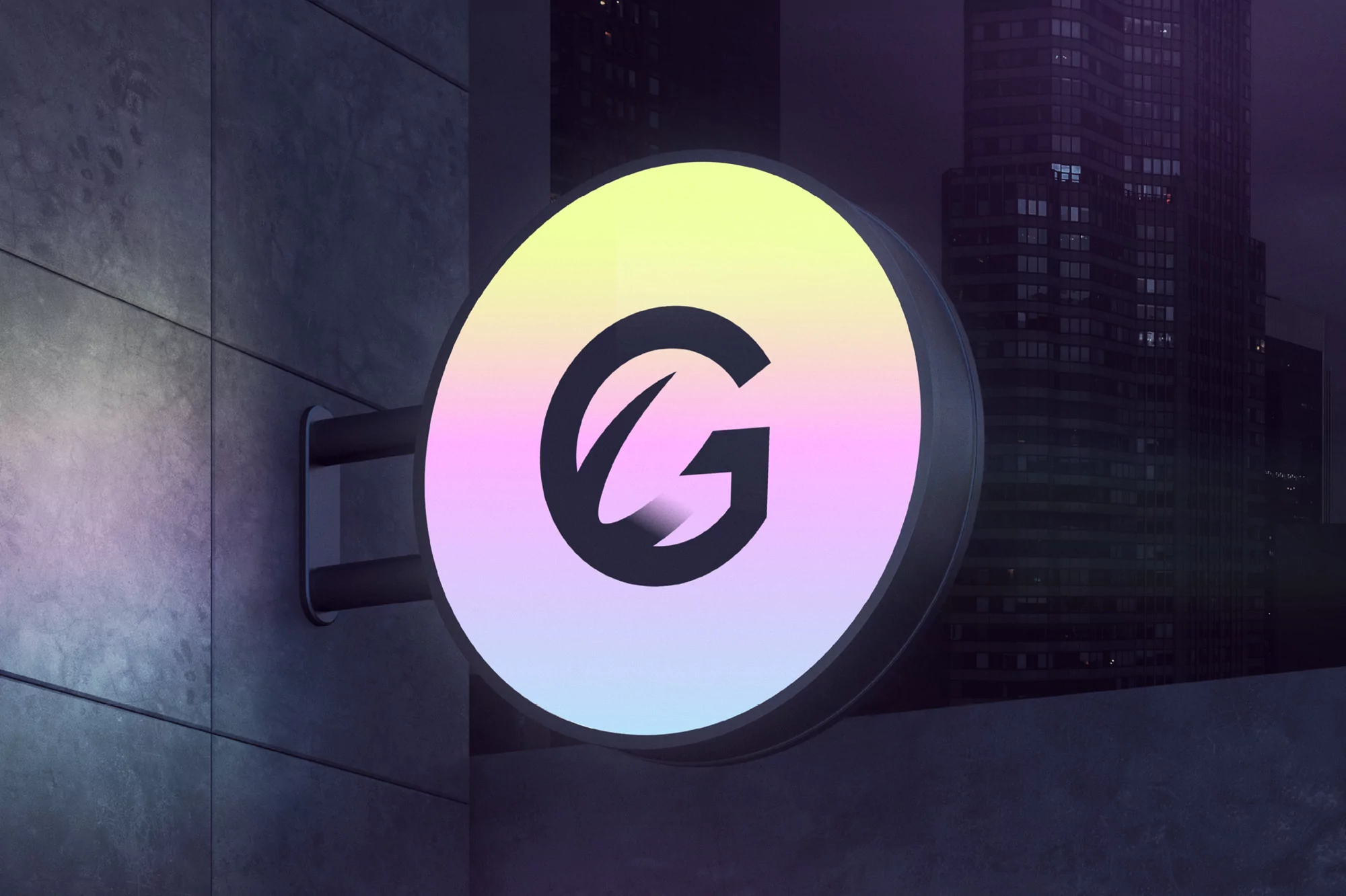 Illuminated sign displaying a stylized 'G' in a gradient of pastel colors mounted on a concrete building in a nighttime urban setting.