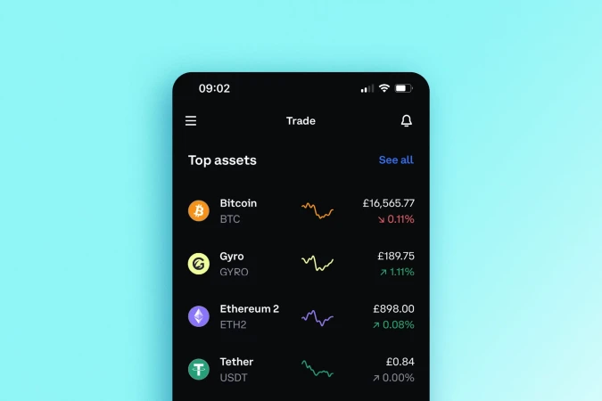 Close-up of a mobile phone screen displaying a cryptocurrency trading app interface with Bitcoin and other asset prices and graphs.