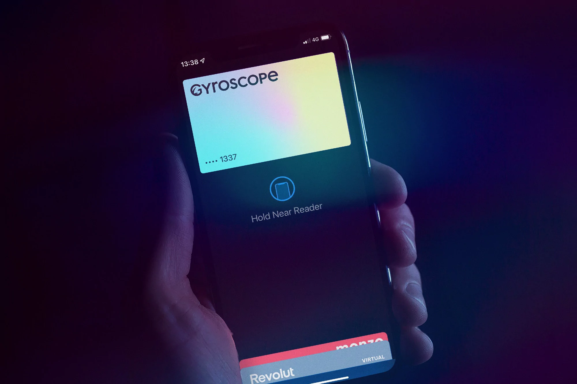 Close-up of a person holding a smartphone displaying a digital wallet with a Gyroscope card, set against a dark background.