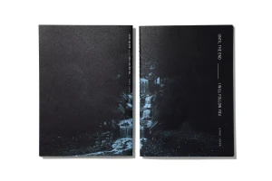 Two dark textured books with white typographic titles displayed side by side on a clean white background