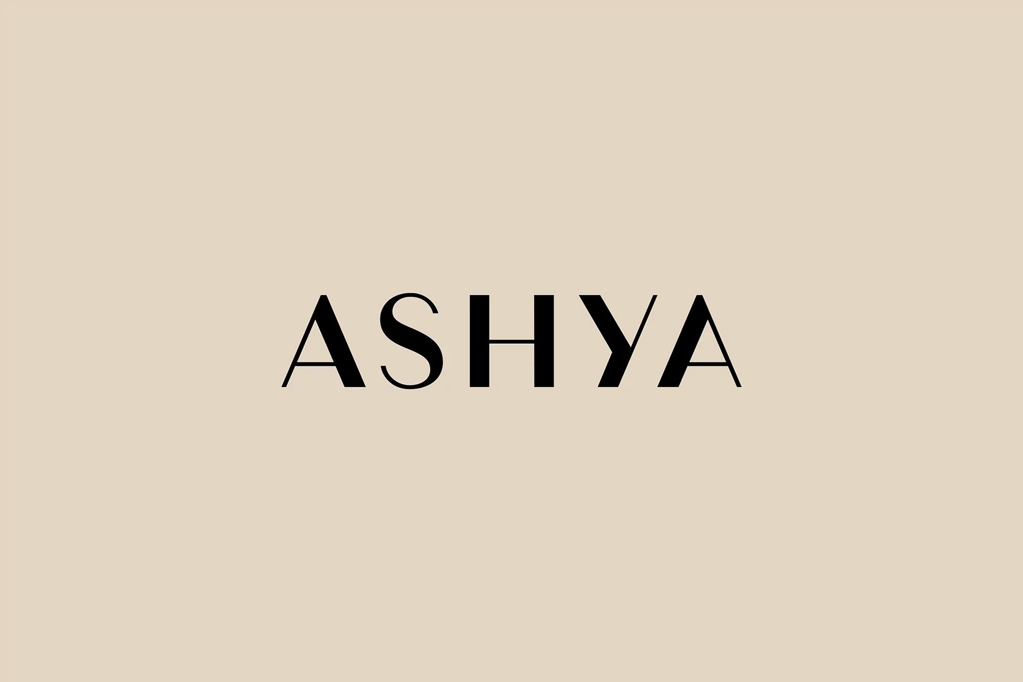 Black sans-serif wordmark “ASHYA” set against a pale beige backdrop, conveying a sense of minimalist sophistication and design.
