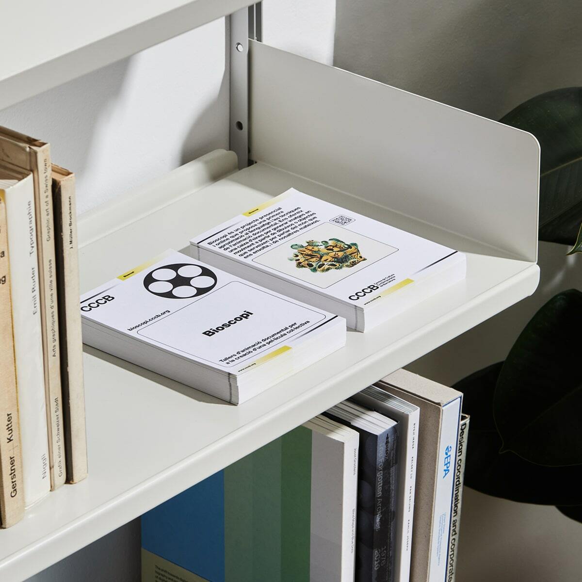 Interior view features a bookshelf with various books and pamphlets, creating an organized and aesthetically pleasing display.