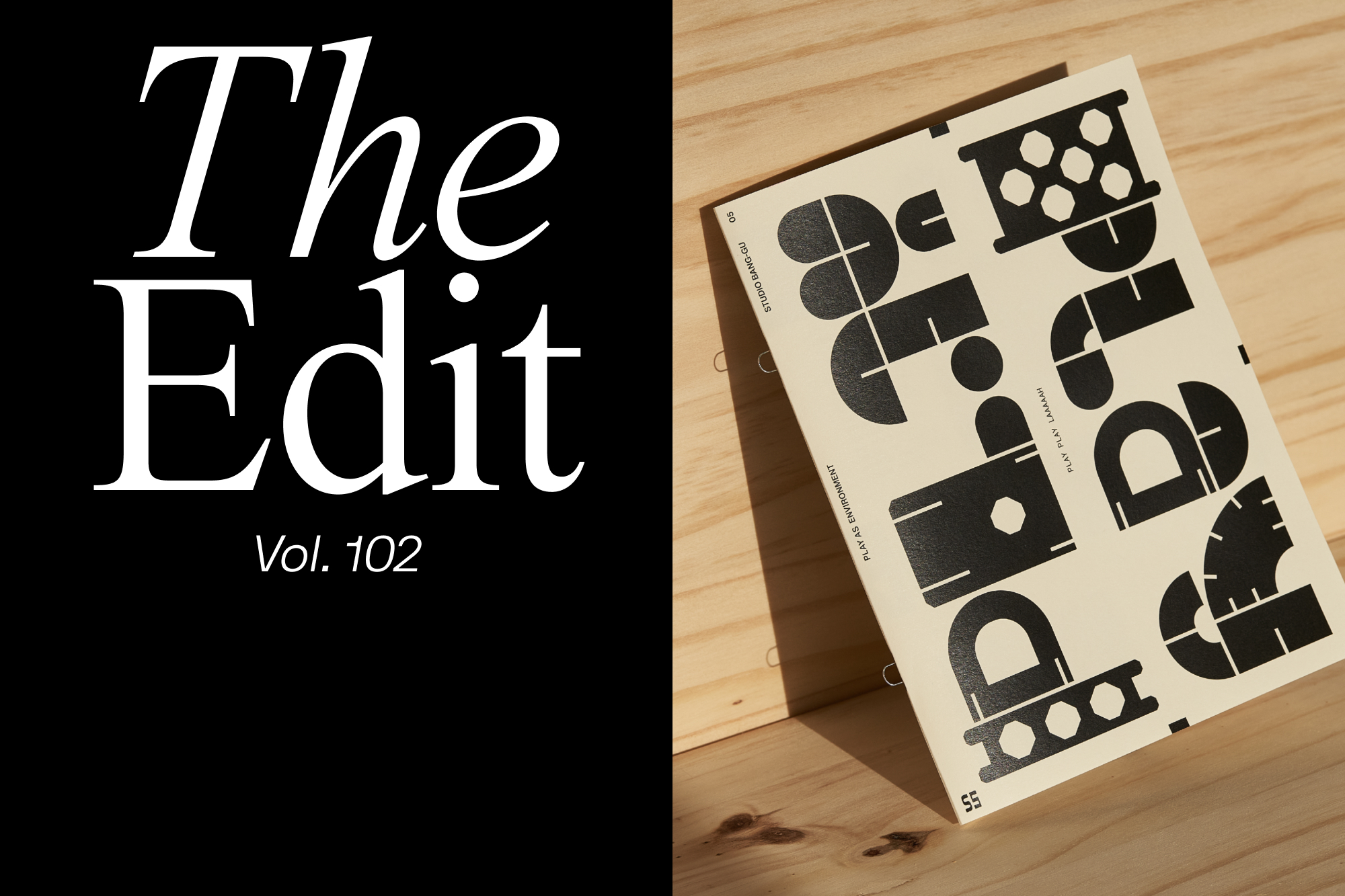 Art book lying on a wooden surface with abstract geometric shapes in black on a cream background, next to The Edit magazine cover.