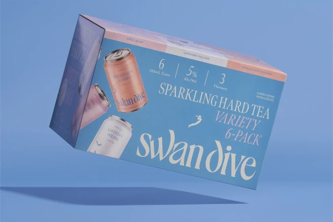 Packaged Swan Dive sparkling hard tea variety 6-pack floats against a blue backdrop. The packaging features the brand name in white script.
