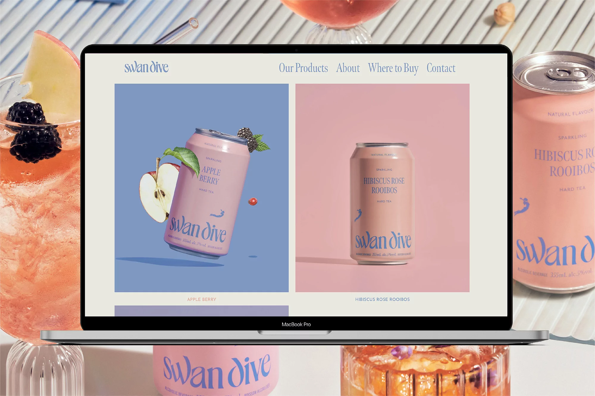 Swan Dive brand drinks on a laptop display, featuring Apple Berry and Hibiscus Rose Rooibos flavors, with associated drinkware.