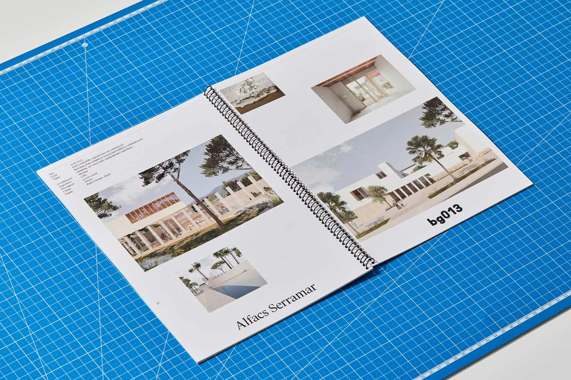 Open magazine spread displaying architectural photography on a blue cutting mat, showcasing modern building designs.
