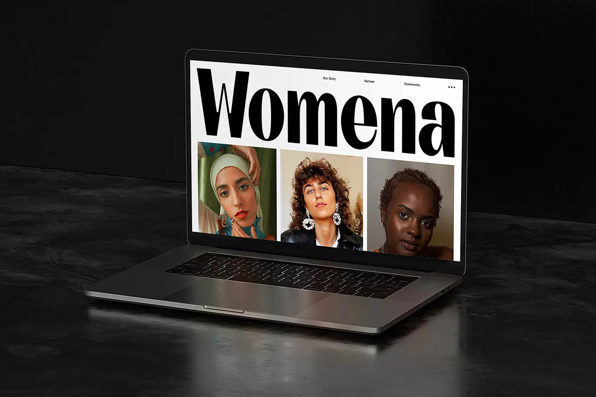 Laptop displaying website with three female portraits and 'Womena' text, set against a dark backdrop.