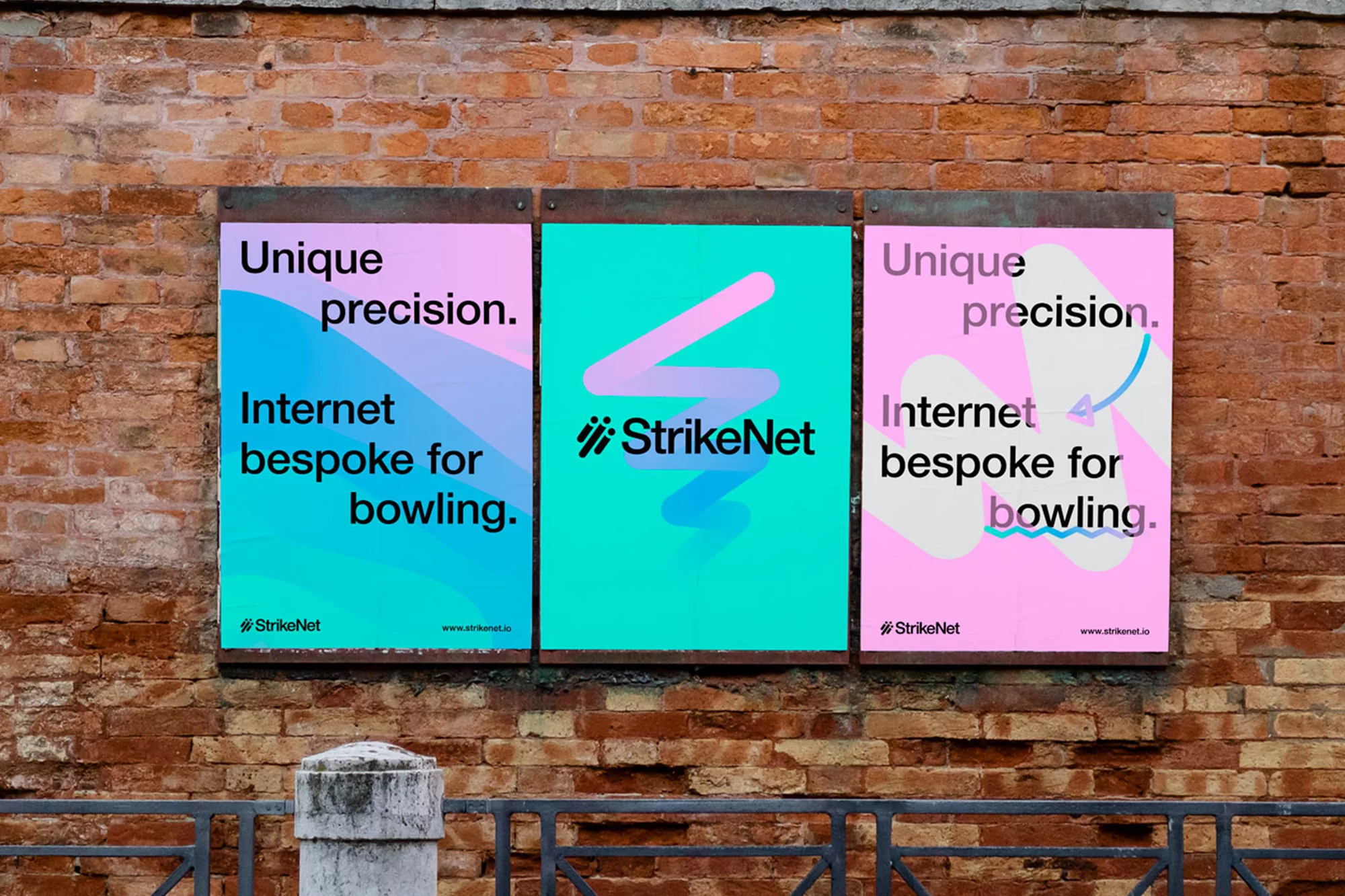 Three advertising posters on a brick wall promote StrikeNet, featuring text about unique precision and Internet bespoke for bowling.