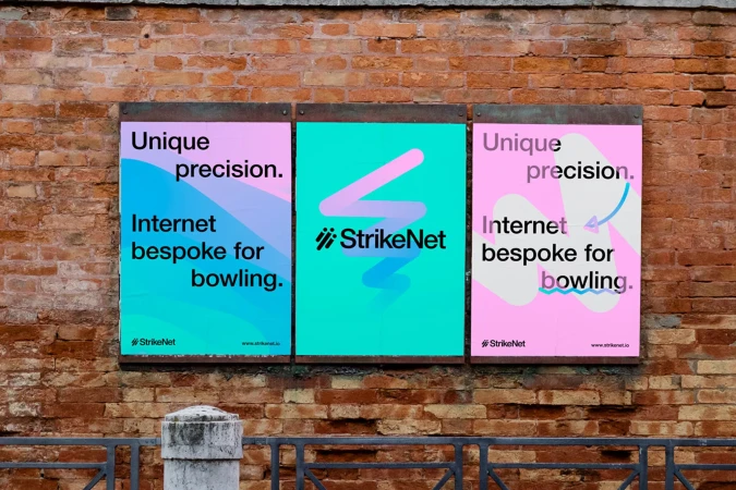 Three advertising posters on a brick wall promote StrikeNet, featuring text about unique precision and Internet bespoke for bowling.