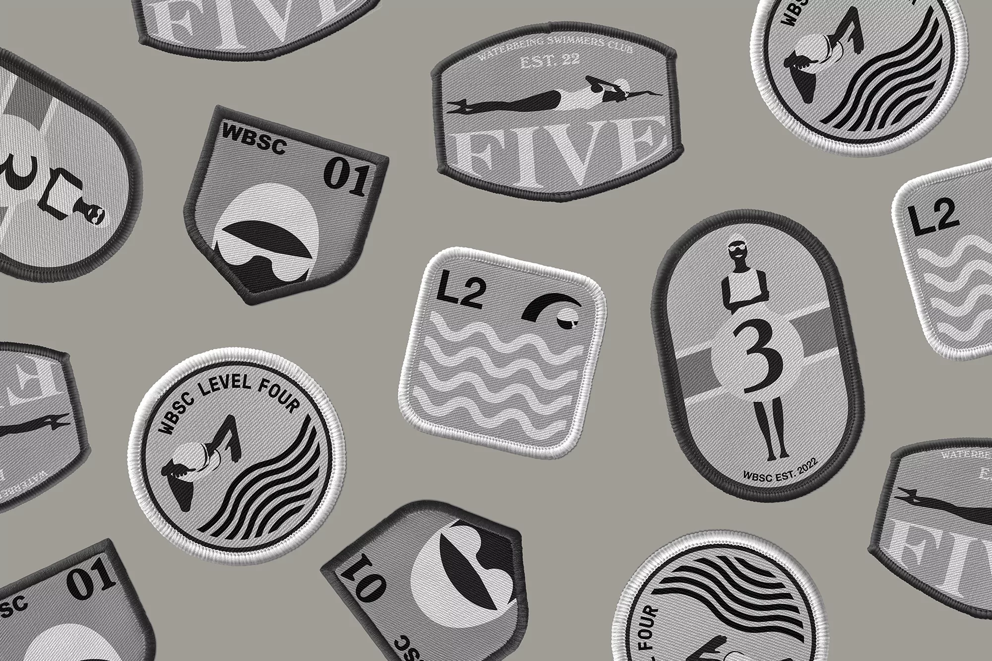 Collection of illustrative patches with swimming and water themes, including emblems and icons in a grayscale color palette.