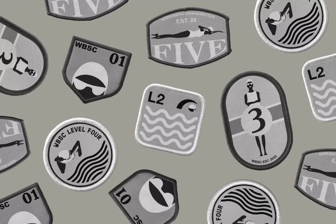 Collection of illustrative patches with swimming and water themes, including emblems and icons in a grayscale color palette.