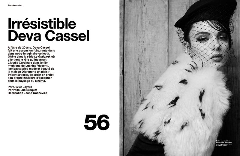 Black and white fashion editorial portrait of a young adult woman wearing a black hat, veil, and fur stole looking at the camera.