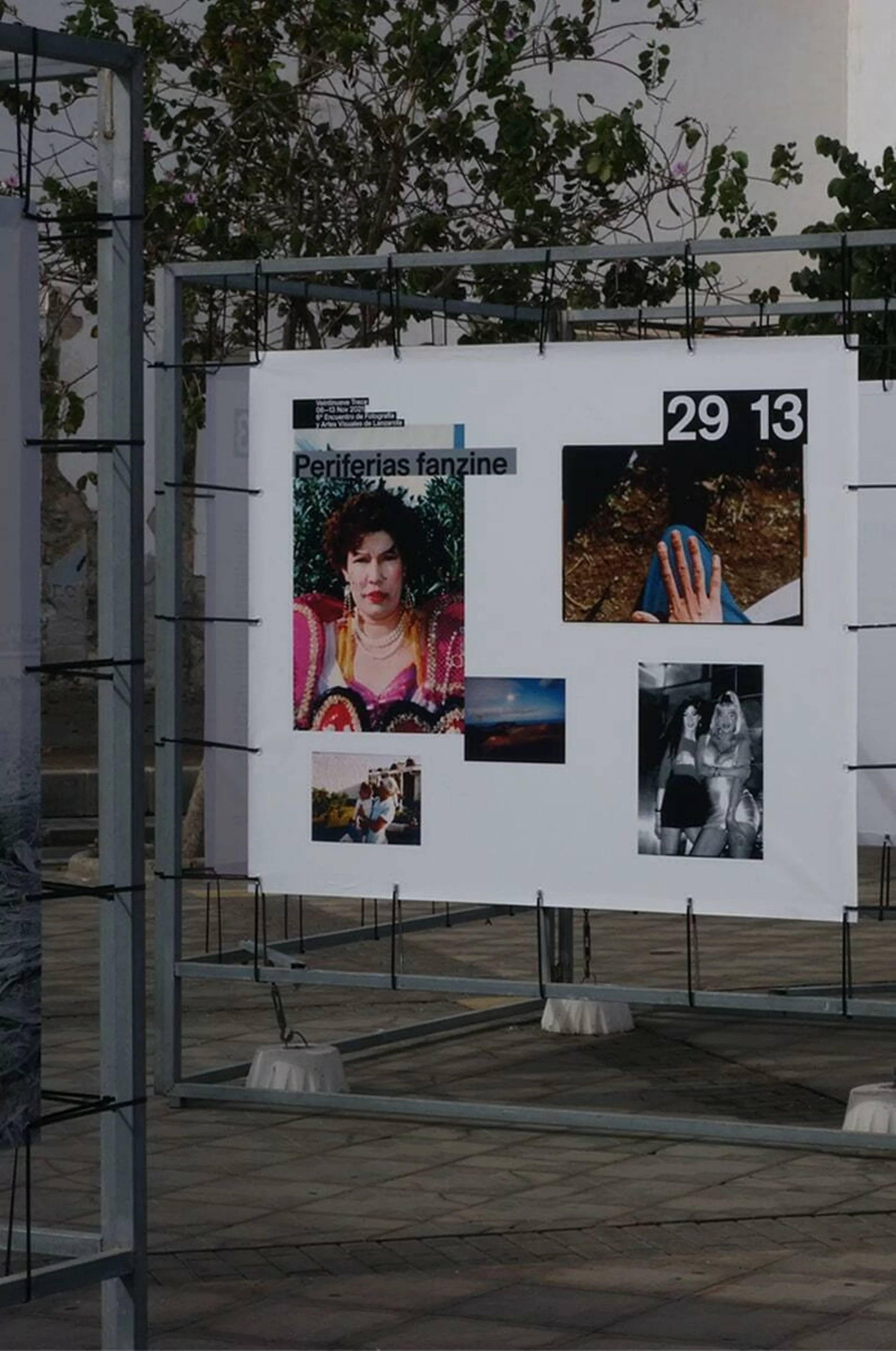 Outdoor art installation displaying multiple photographs with people and landscape subjects under natural daylight, showcasing creative photography.
