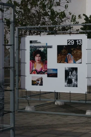 Outdoor art installation displaying multiple photographs with people and landscape subjects under natural daylight, showcasing creative photography.