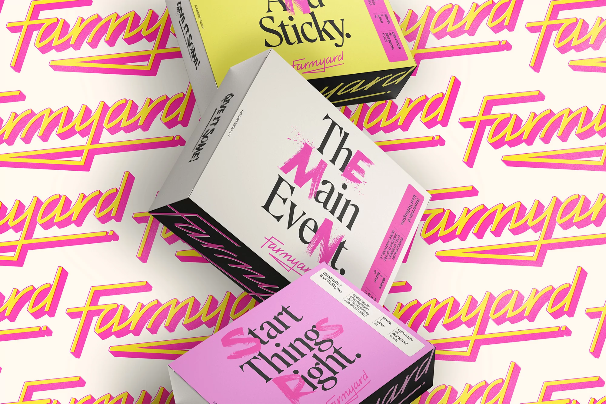 Three Farmyard brand boxes are stacked on a surface featuring a repeated Farmyard logo design in pink and yellow on a white backdrop.