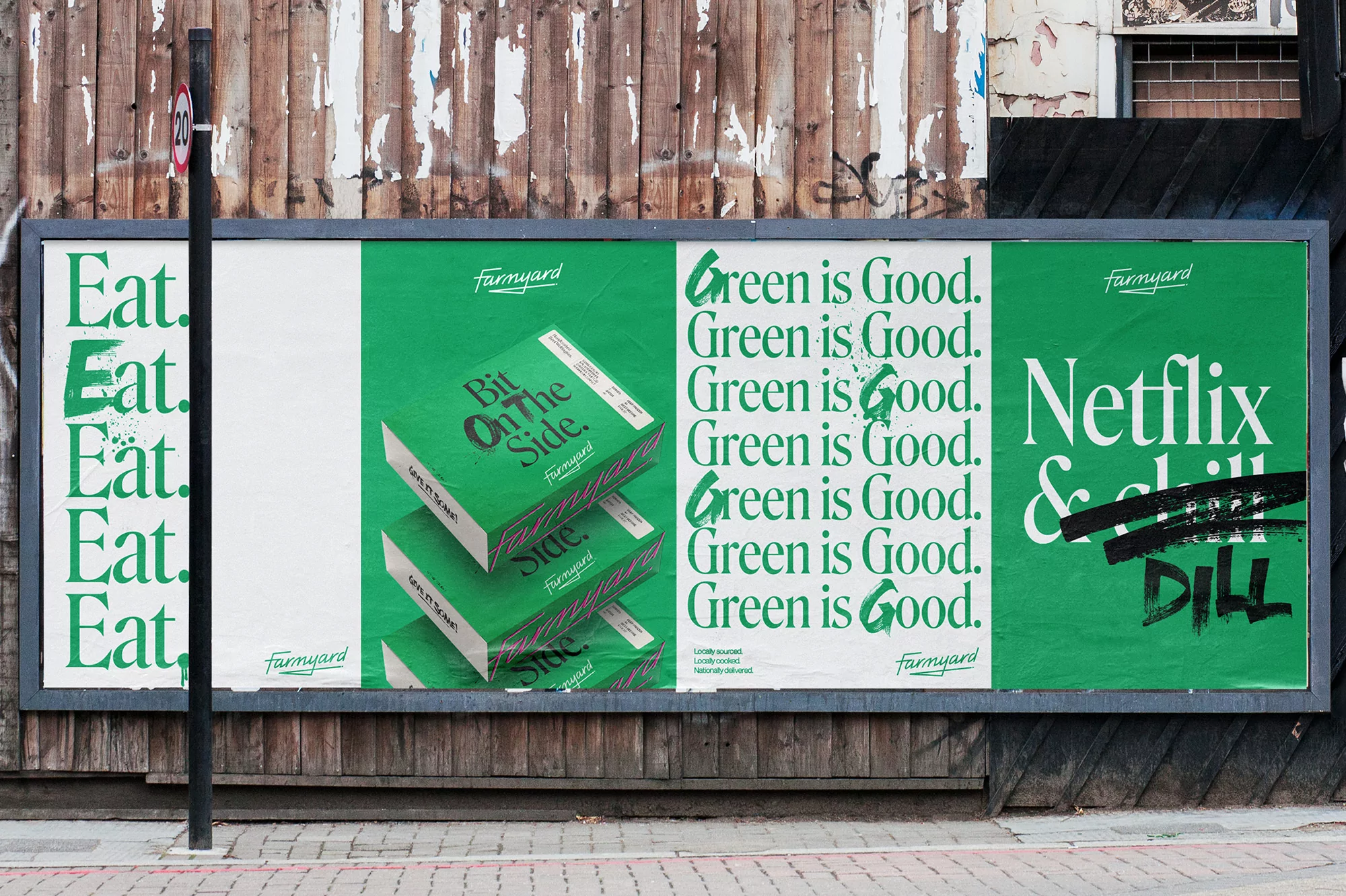 Outdoor shot of a billboard featuring promotional posters with the brand Farmyard in green and white, mounted on an aged, wooden surface.